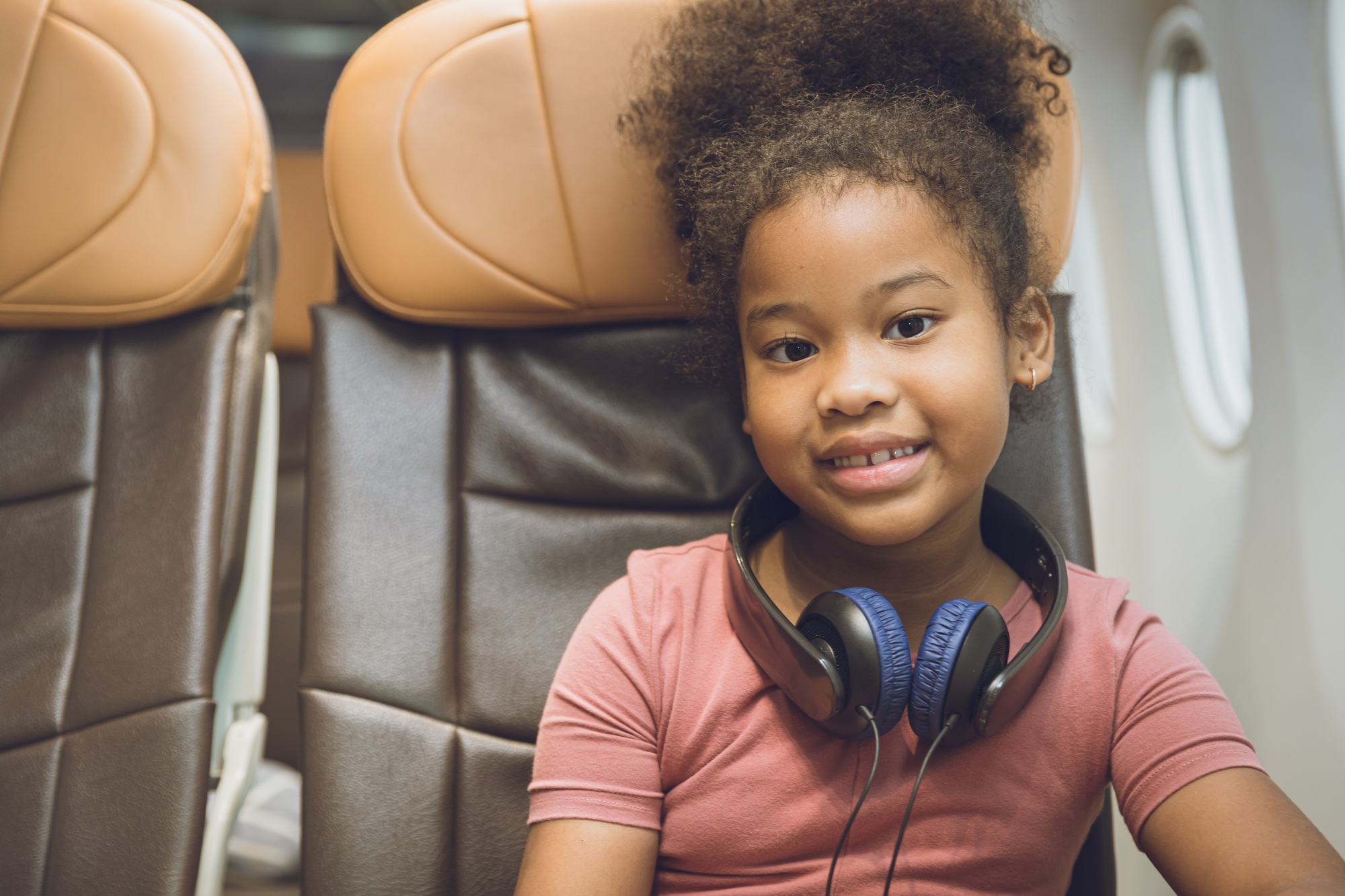 children traveling alone or unaccompanied minor. child girl fly travel sitting alone in flight cabin